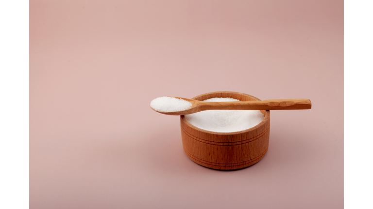 Sugar substitute. Stevioside powder or Stevia sweetener in wooden bowl. Food additive E960. Natural Extract found in the leaves of Stevia rebaudiana