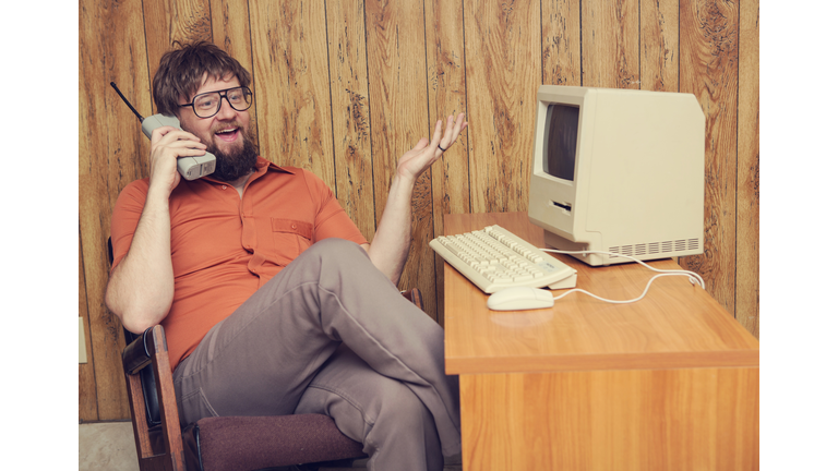 retro cell phone 1980s man at computer