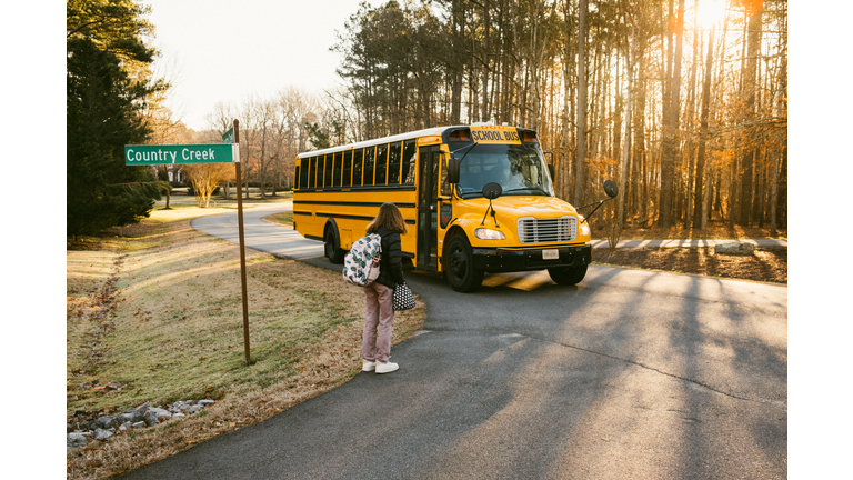 Junior High Student wait at School Bus Stop