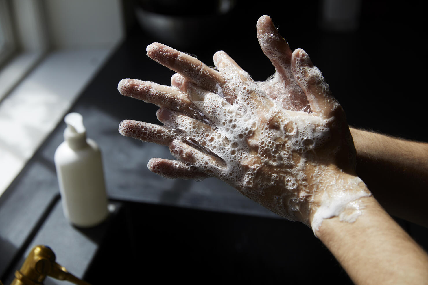 Young man washing hands