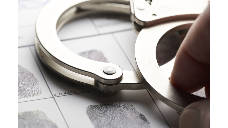 Handcuffs on fingerprint document from getting arrested