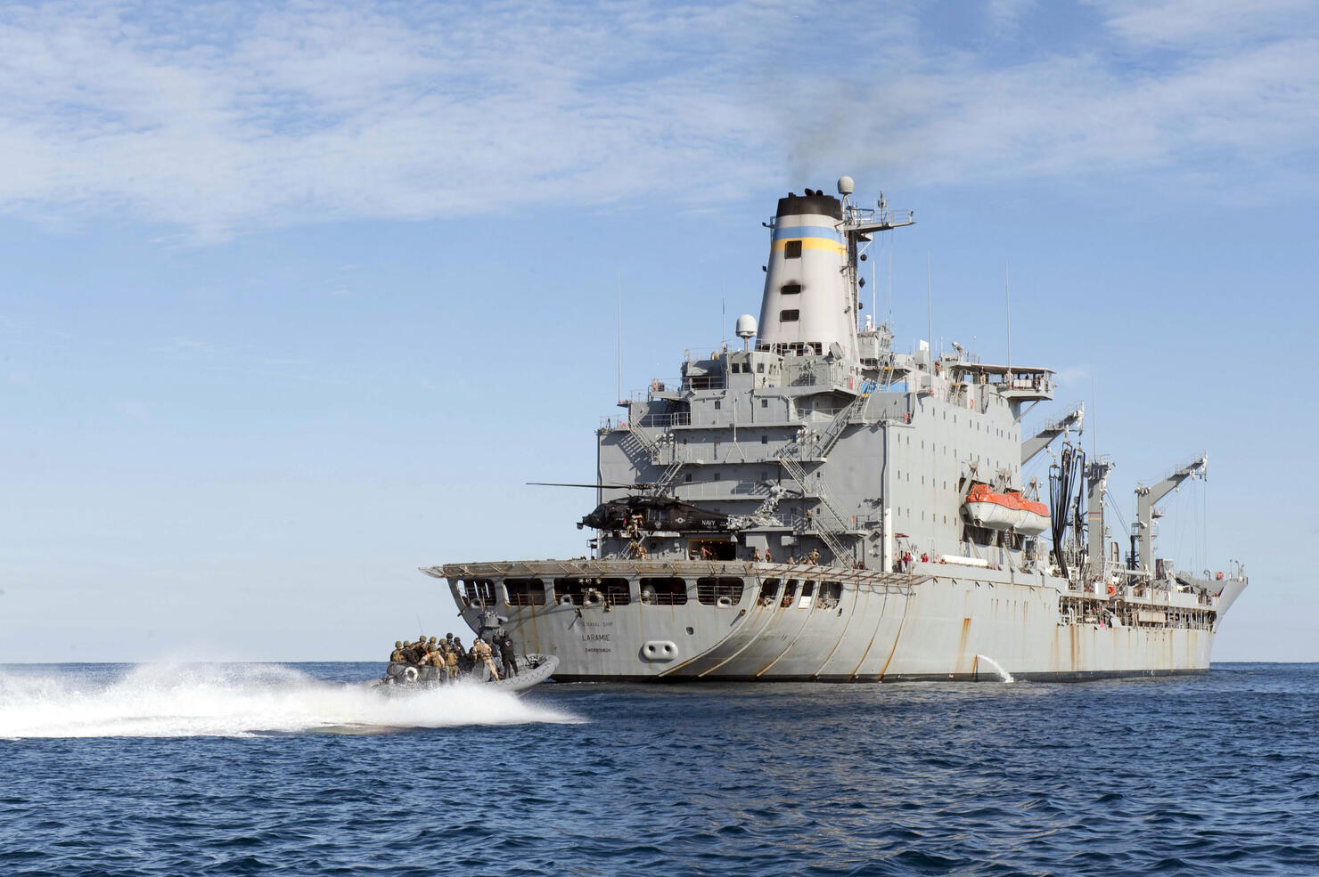 Marines in an inflatable boat head towards USS New York.