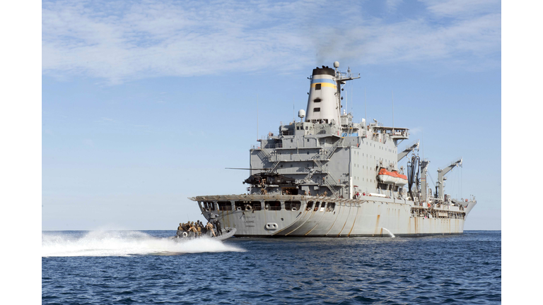 Marines in an inflatable boat head towards USS New York.