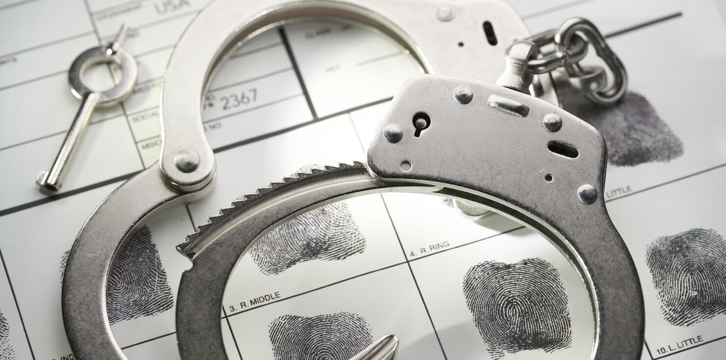 Handcuffs on fingerprint document from getting arrested