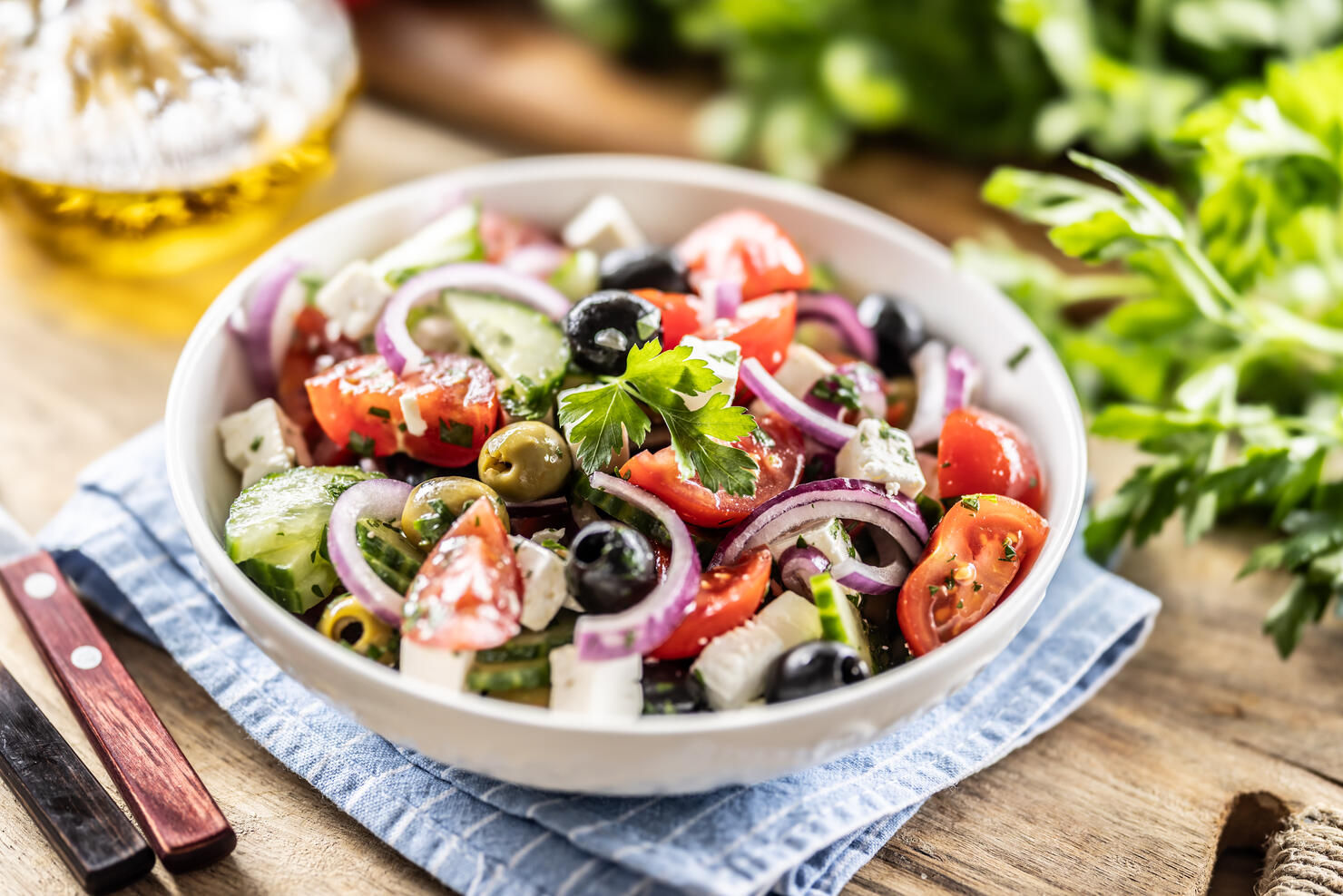 A healthy Mediterranean salad of Greek origin consisting of tomatoes, cucumbers, olives and Feta cheese, seasoned with parsley and olive oil.