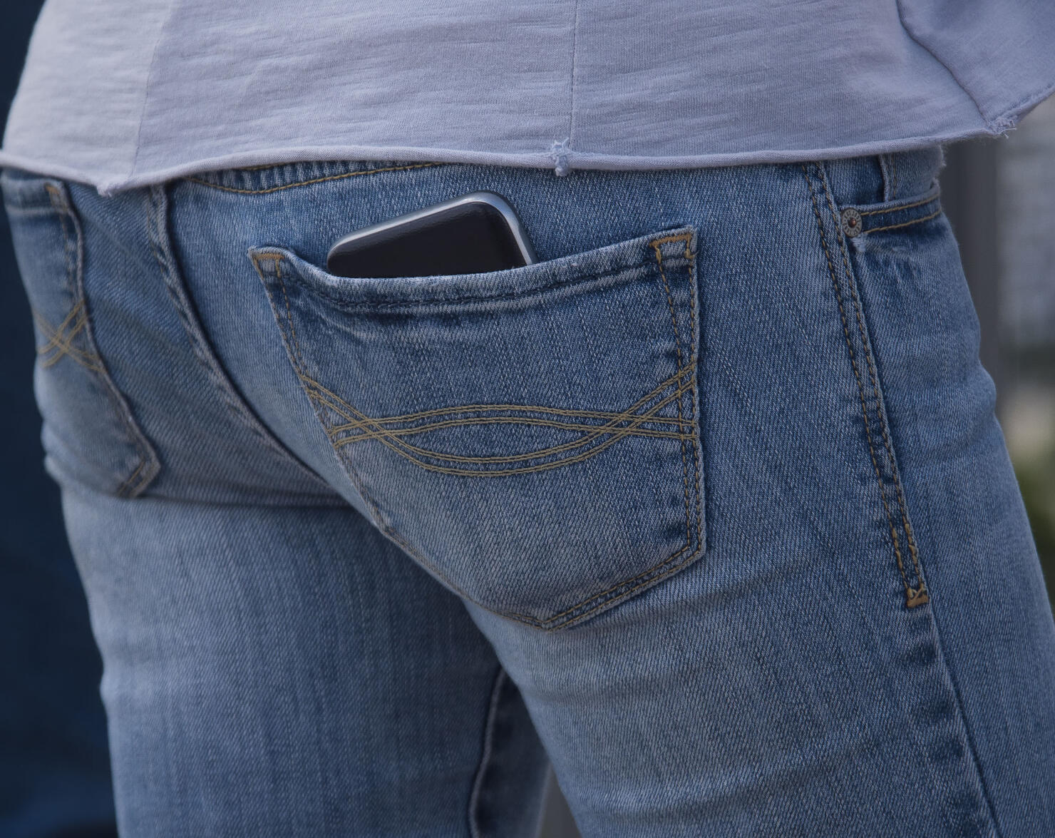 Mobile phone in a blue jeans pocket