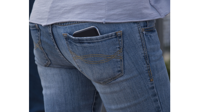 Mobile phone in a blue jeans pocket