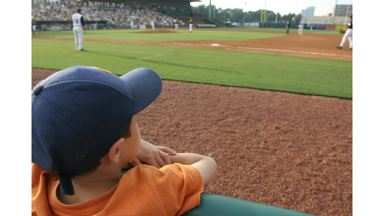 Little boy at baseball game dreams concept