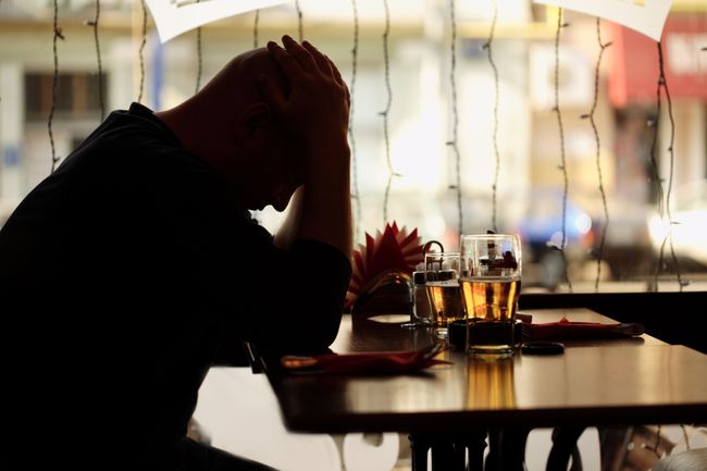 sad man sitting in restaurant