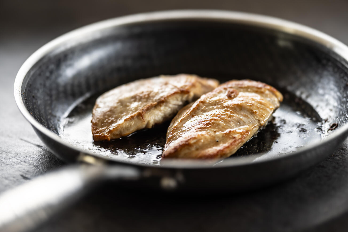 Chicken breast baked in olive or vegetable oil in a non-stick steel pan