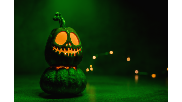 Halloween pumpkin jack o' lantern on acid green background