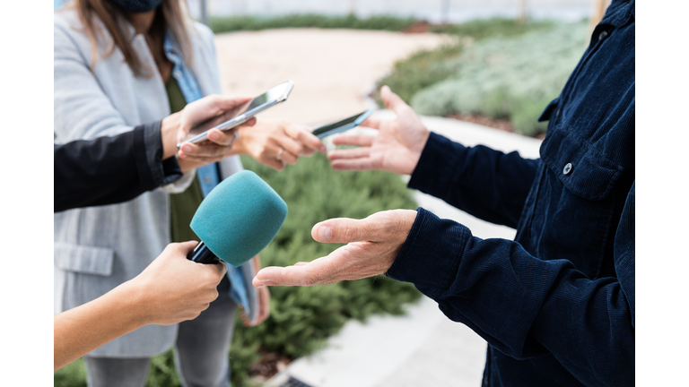 Close-up of an interview with smartphones and microphone - stock photo