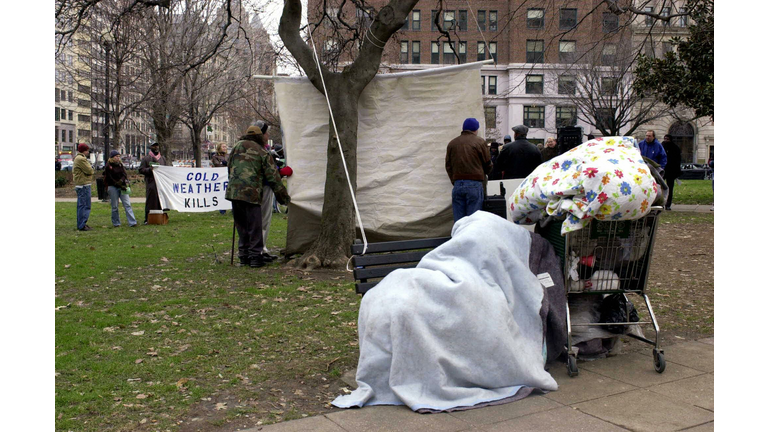An unidentified homeless man (front) lay