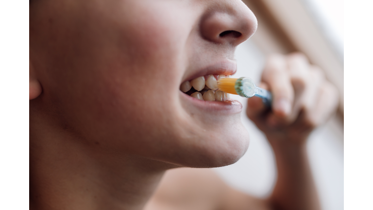 Brushing teeth for a healthy, clean smile.