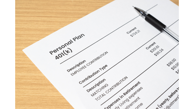 Retirement banking plan 401k and white pen on a white background. Close-up