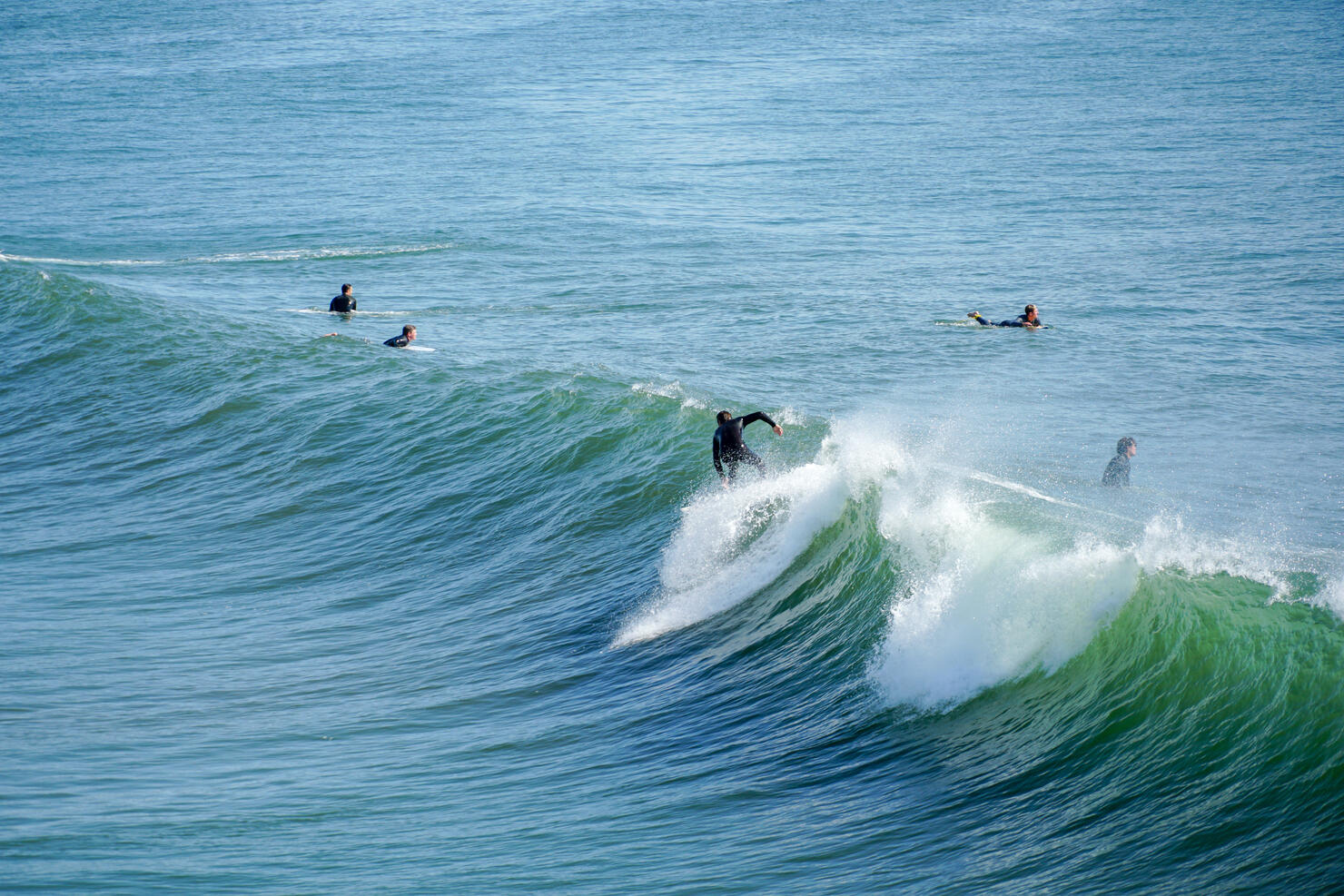 Male surfers enjoying the big waves in Oceanside in North San Diego, California, USA.