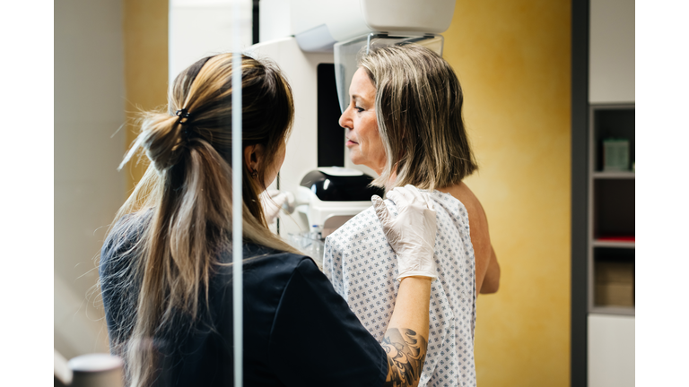 Nurse Assisting Patient During Mammogram