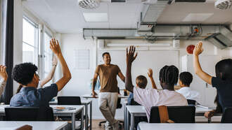 WATCH: Teacher Goes Viral For Custom Handshakes With Students