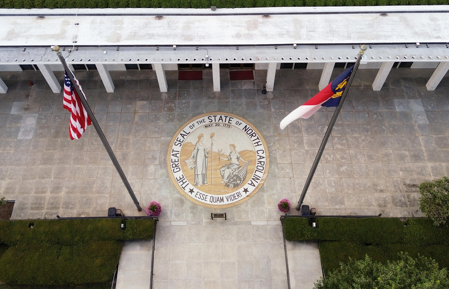 Aerial view of the North Carolina State legislature building with the state seal at the entrance