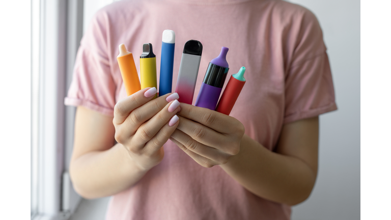 Vape cigarettes in woman hand