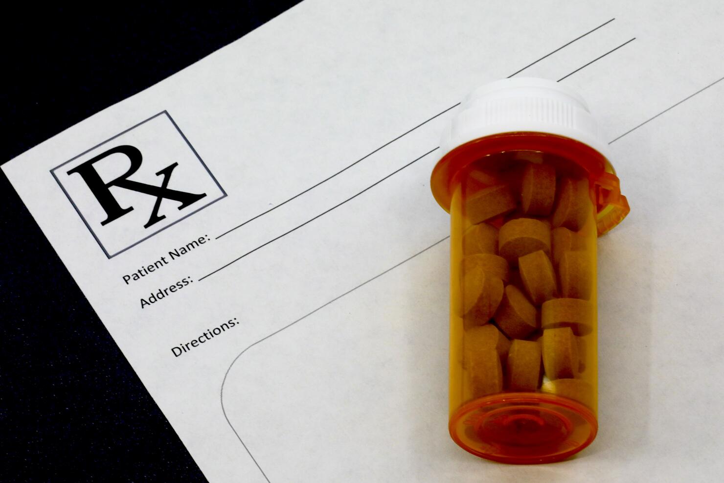Doctors prescription and bottle of pills