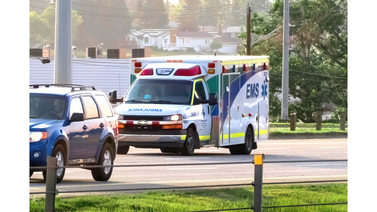 An EMS ambulance on the route during summer time.