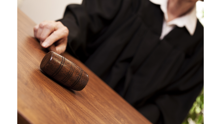 Judge in black robe with gavel