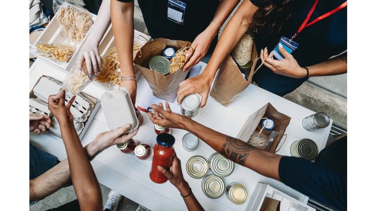 Volunteers preparing grocery bags for donation to needy people