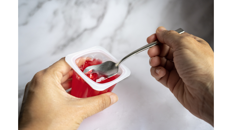 Woman Eating Red Gelatin.