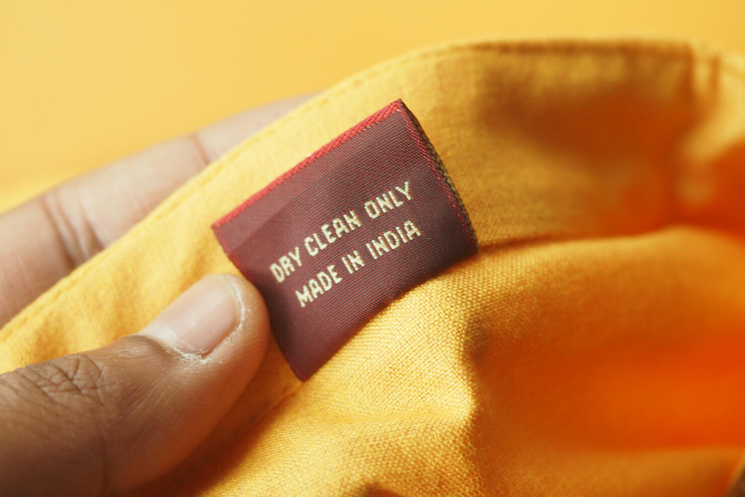 Clothing label showing care instructions and origin details