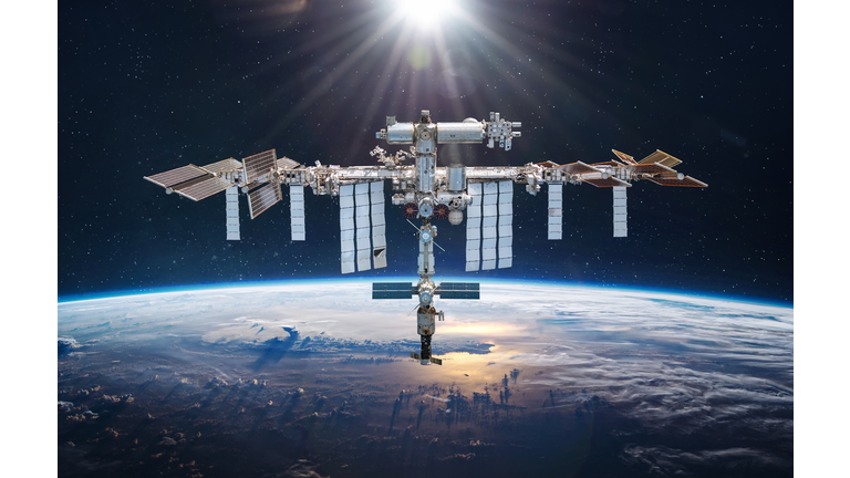 International space station in 2022 in outer space. ISS floating on orbit of Earth planet. Space sci-fi collage with satellite and spaceship. Astronauts on orbit. Elements of this image furnished by NASA