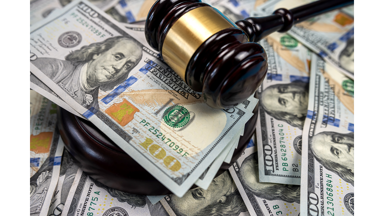 Gavel cash dollar bills and financial crimes.