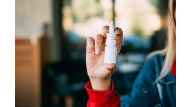 Young Woman Holding Nasal Spray
