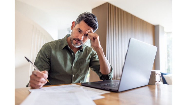 Man working at home and looking worried