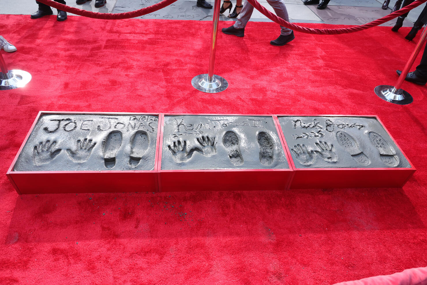 Jonas Brothers Hand And Footprint In Cement Ceremony At TCL Chinese Theater
