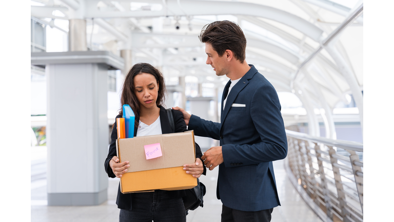 Man consoling his working colleagues being fired lost the job