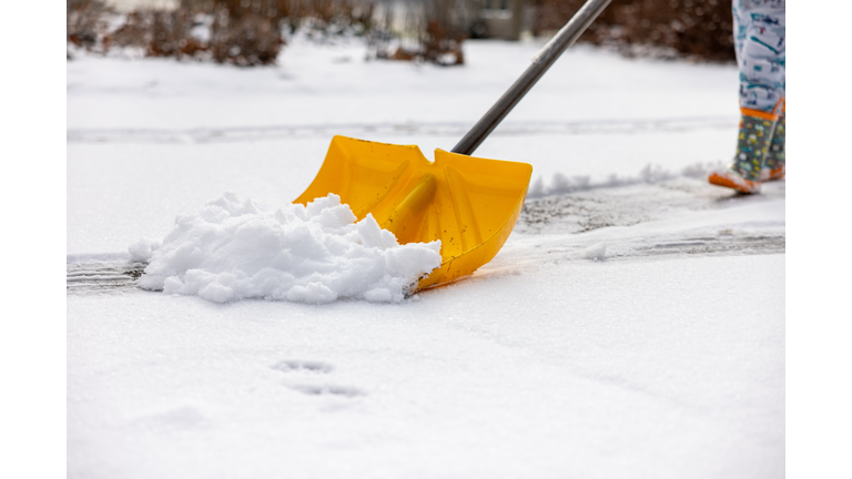 Child Pushing Snow Shovel