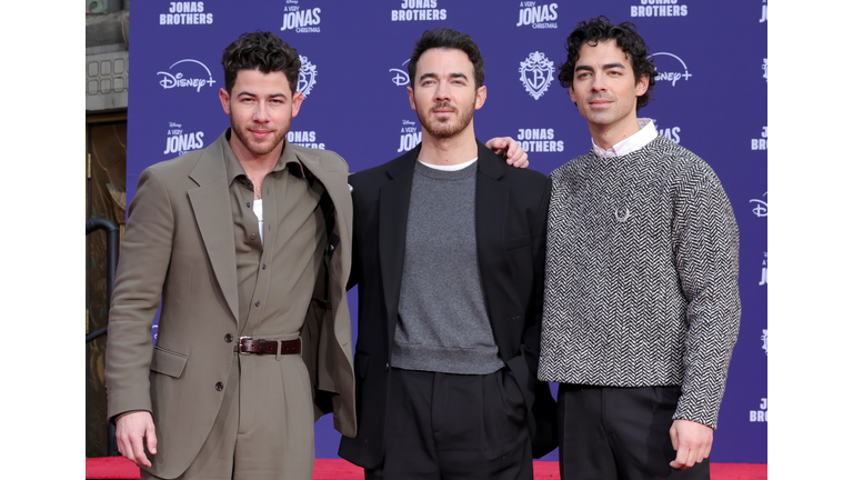 Jonas Brothers Hand And Footprint In Cement Ceremony At TCL Chinese Theater