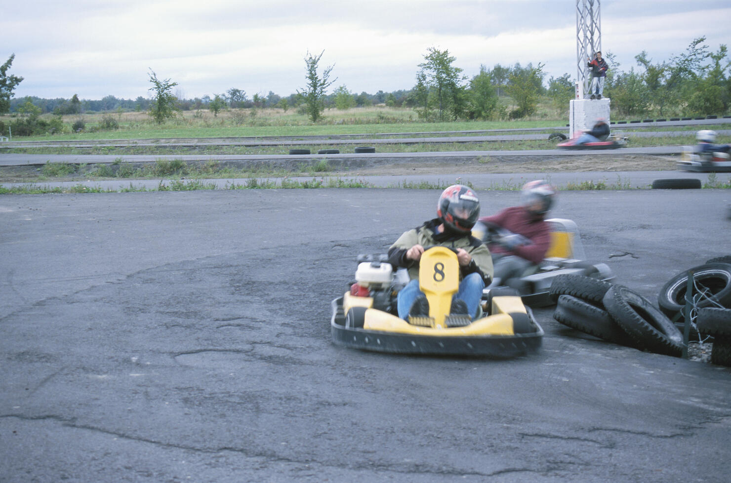 People driving around tires in go-cart