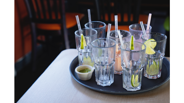 Tray with Empty Glasses and Leftovers in a Restaurant