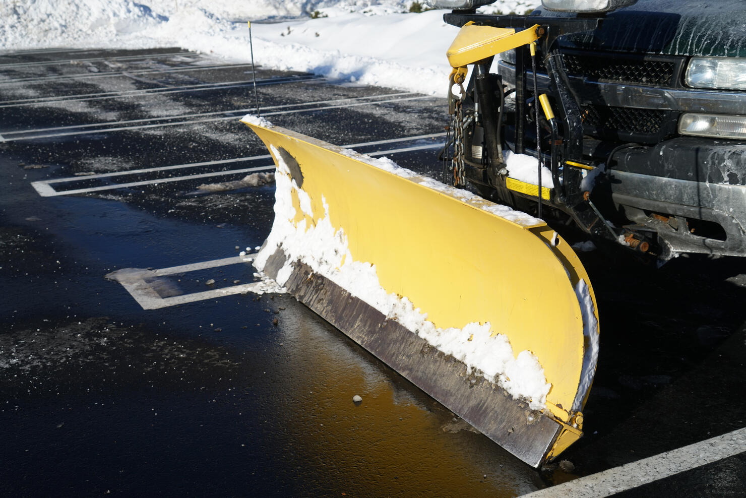 truck with snowplow installed in the parking lots