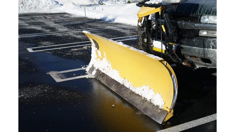 truck with snowplow installed in the parking lots
