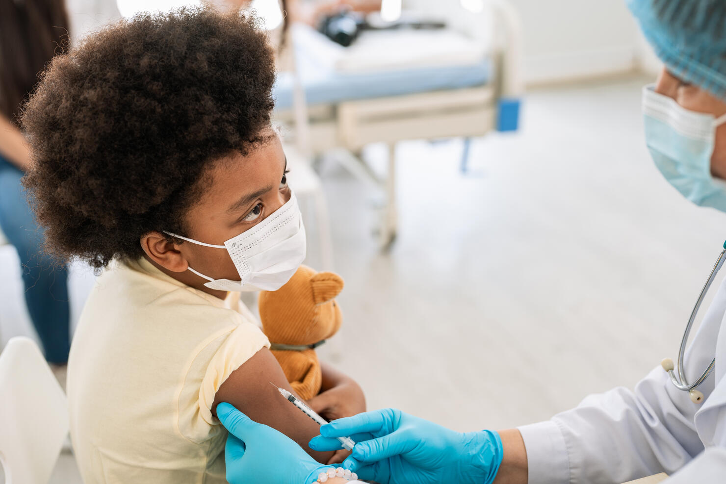 Young African American little boy taking a Covid 19 vaccine