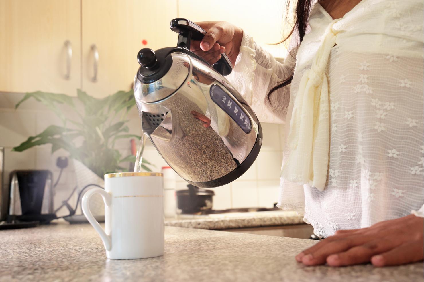 pouring water from kettle into mug