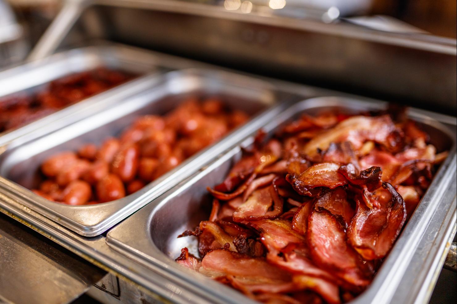 Various meat in steel containers for serving in a buffet at restaurant