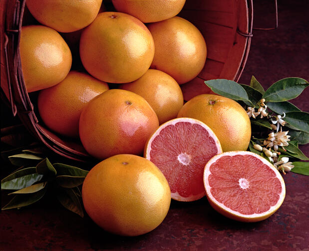 View of a basket of ruby red grapefruits, with one grapefruit cut in half, 2010. (Photo by Tom Kelley/Getty Images)