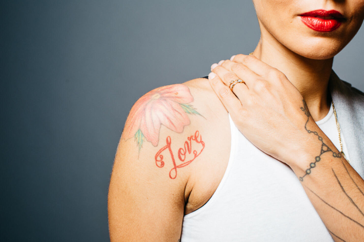Pink Hibiscus Flower Shoulder Tattoo and orange Cursive Love Lettering Tattoo