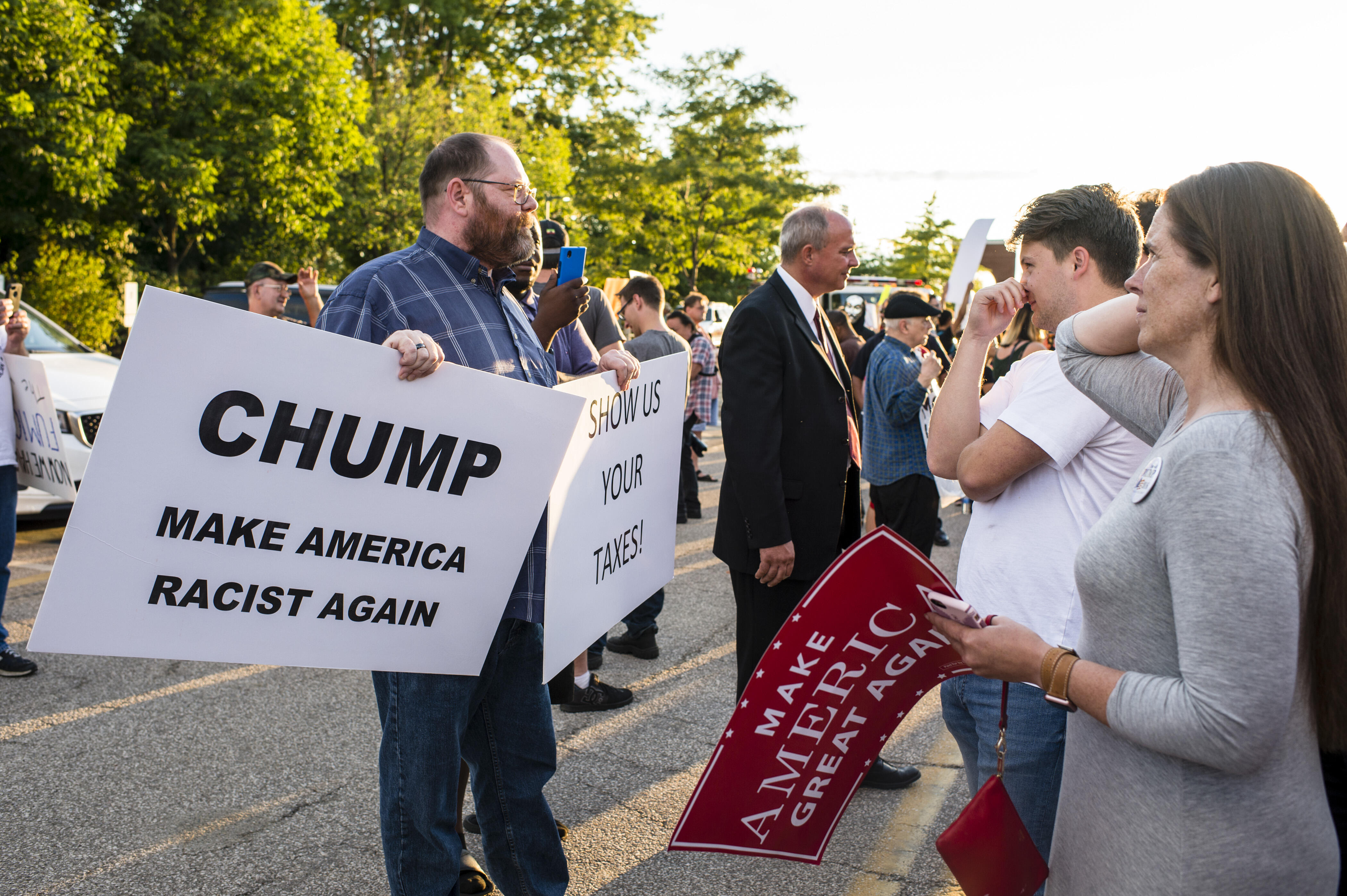 AKRON, OH - AUGUST 22: A Trump supporter (center-right) confronts a protestor (left) outside of a rally for US Republican Presidential candidate Donald Trump at the James A. Rhodes Arena on August 22, 2016 in Akron, Ohio.  Trump currently trails Democratic Presidential candidate Hillary Clinton in Ohio, a state which is critical to his election bid. (Photo by Angelo Merendino/Getty Images)