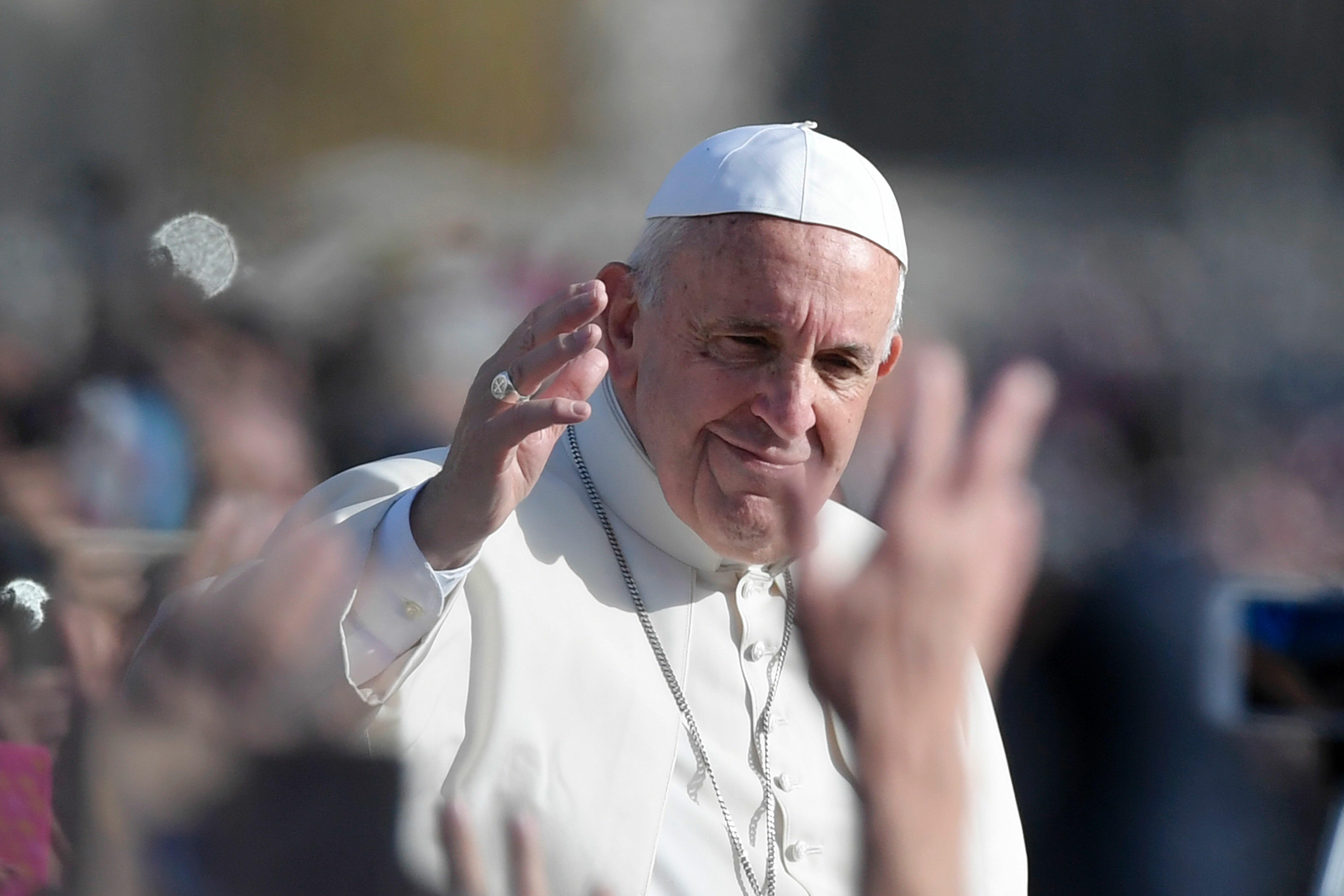 Pope Francis greets the crowd from the popemobile after the celebration of a mass marking the end of the Jubilee of Mercy, on November 20, 2016 in Vatican.  Pope Francis on Sunday brought to a close the Catholic Church's 