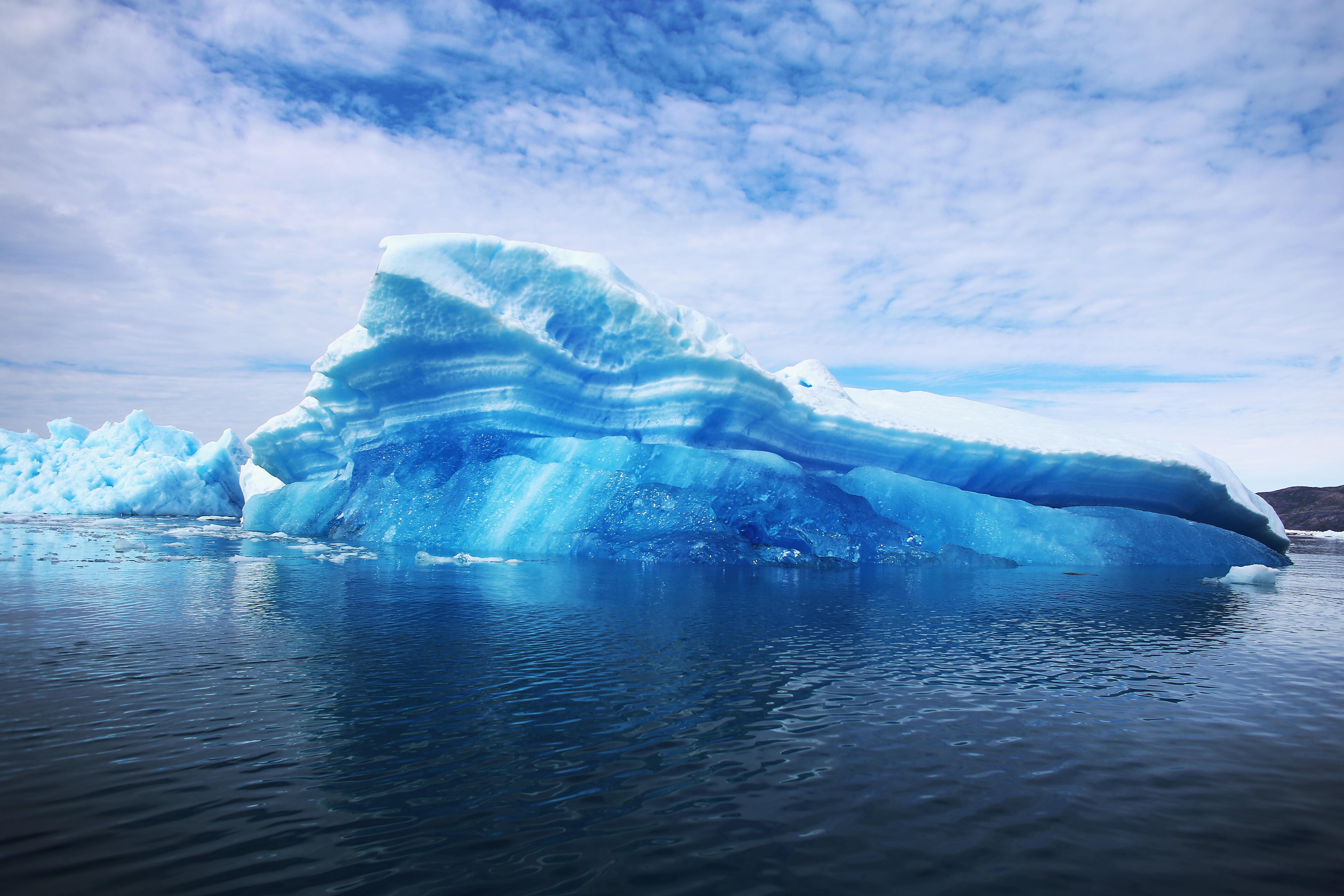 QAQORTOQ, GREENLAND - JULY 30:  Calved icebergs from the nearby Twin Glaciers are seen floating on the water on July 30, 2013 in Qaqortoq, Greenland. Boats are a crucial mode of transportation in the country that has few roads. As cities like Miami, New Y